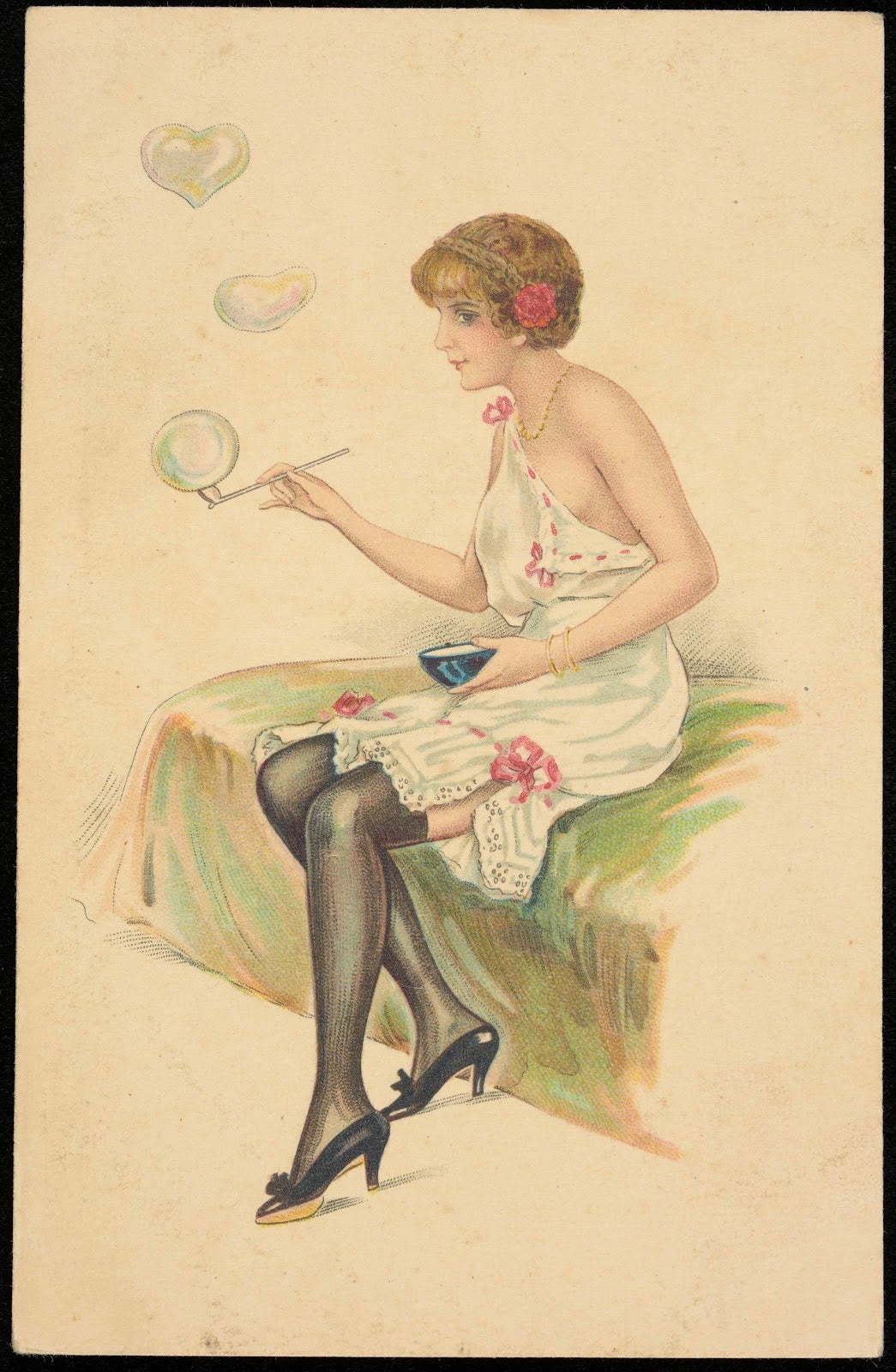 A woman in a negligee blows soap bubbles 20th century