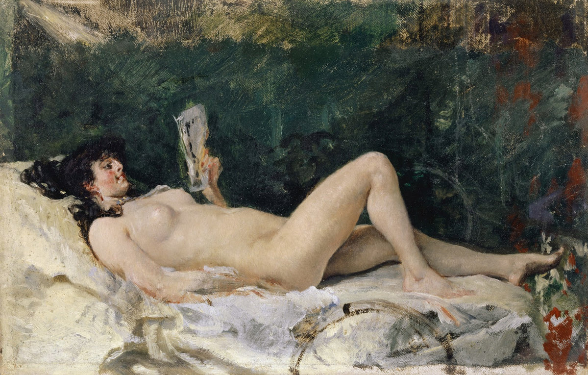 Young Woman Lying on a Bed and Reading