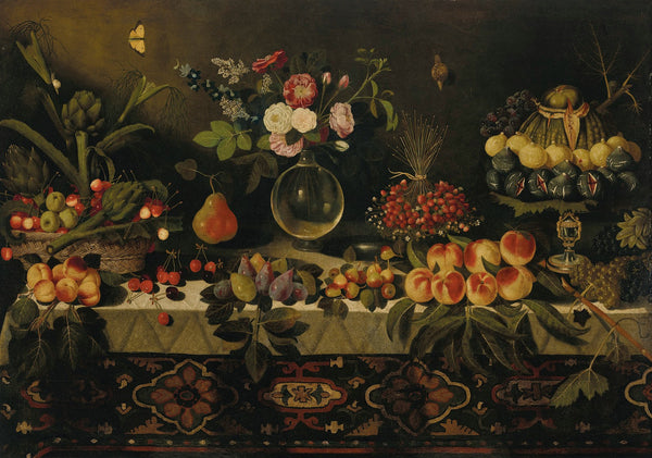 A draped table laden with fruit and flowers in a glass vase